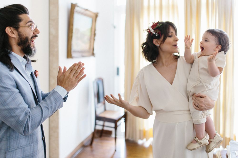 Joyful wedding day moment captured in bright interior setting.