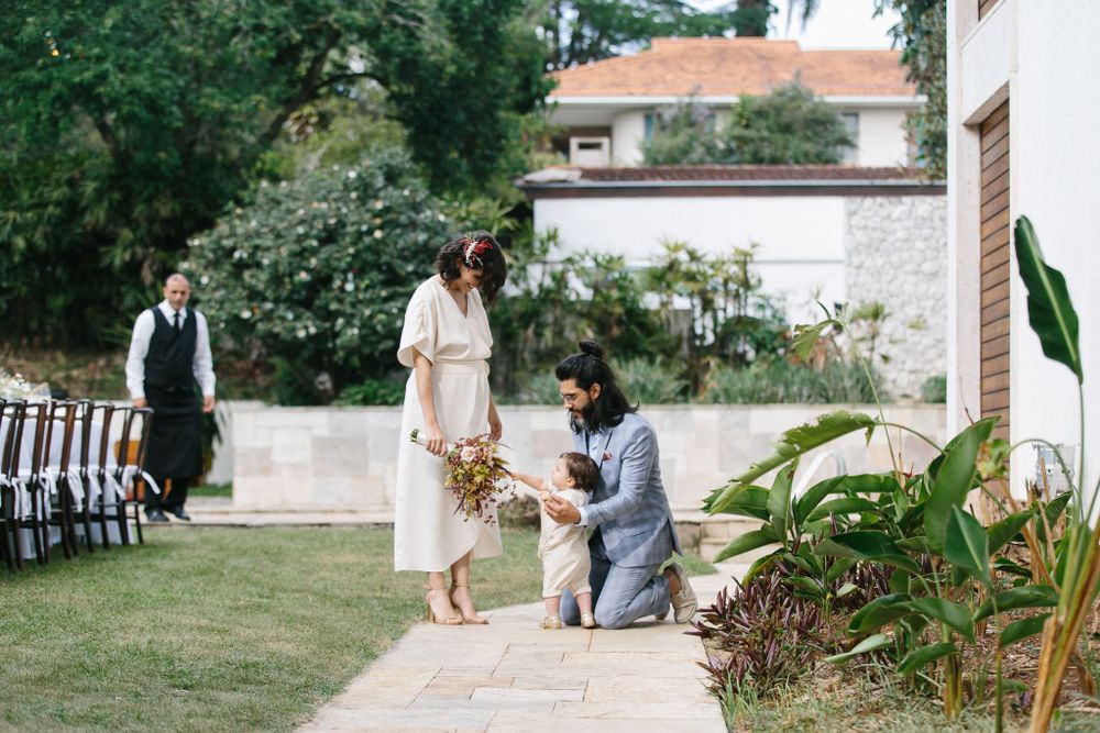 Special moment during an outdoor wedding ceremony in a garden setting.