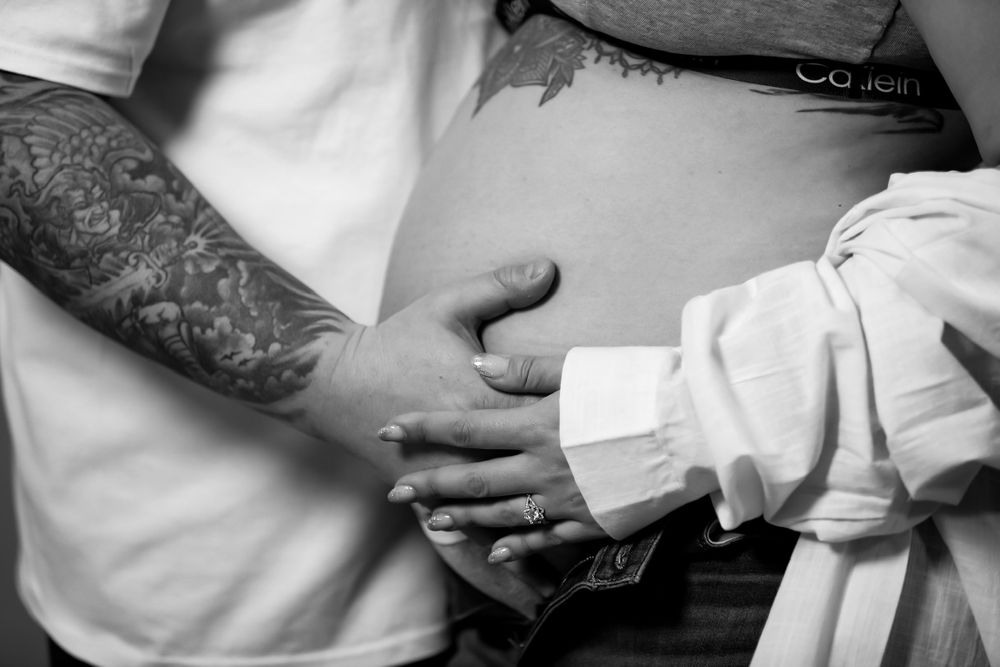 Close-up shots of hands tenderly touching during an intimate photo session.