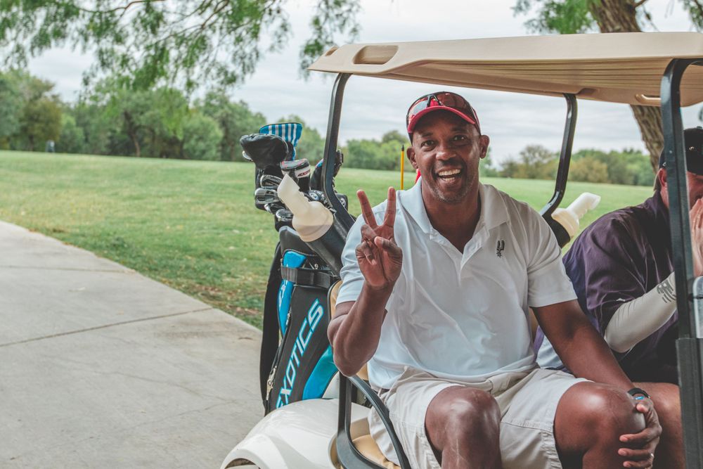 People relaxing in golf carts during a sunny day on the course.