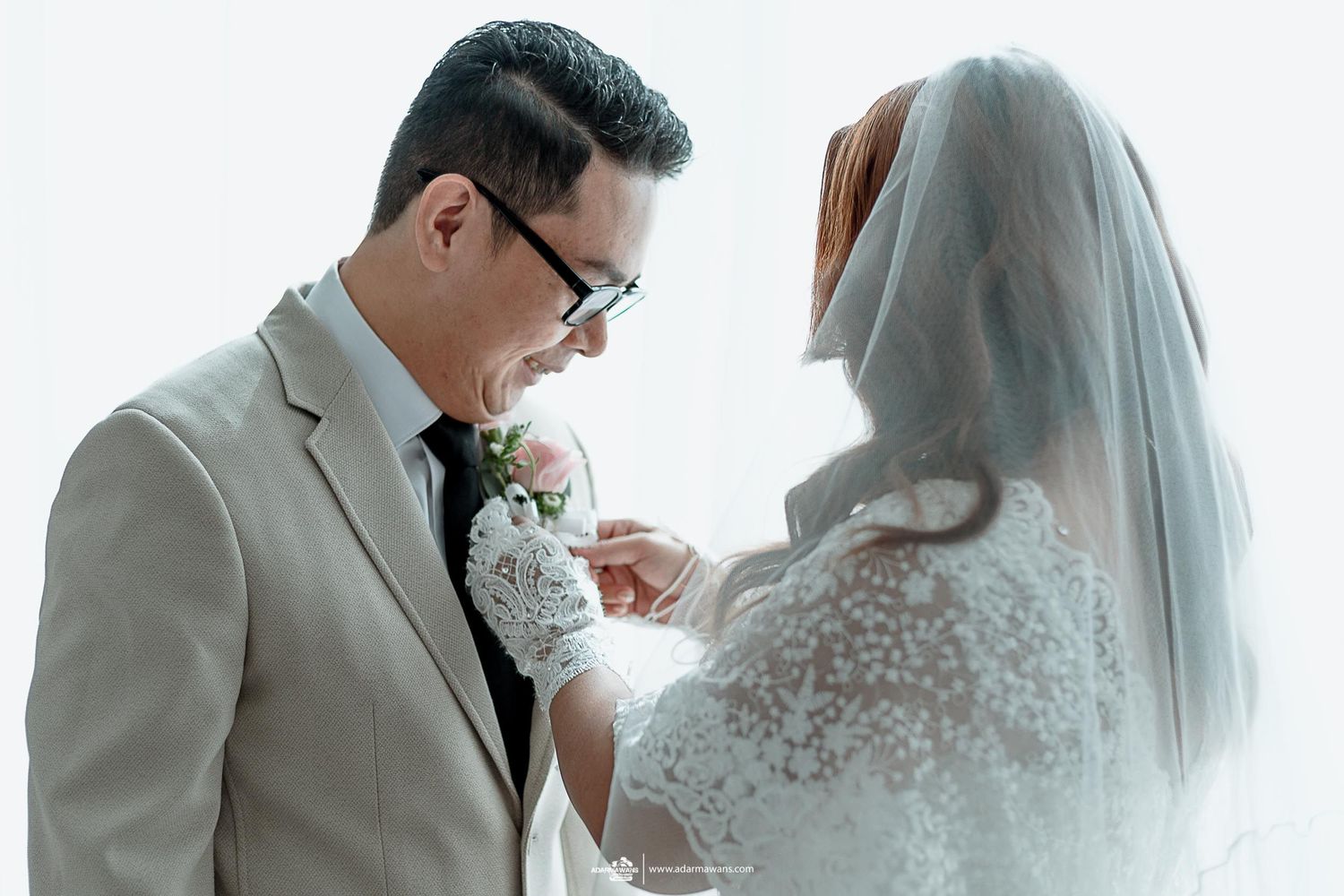 Intimate wedding portrait with gentle touches and delicate lace details.