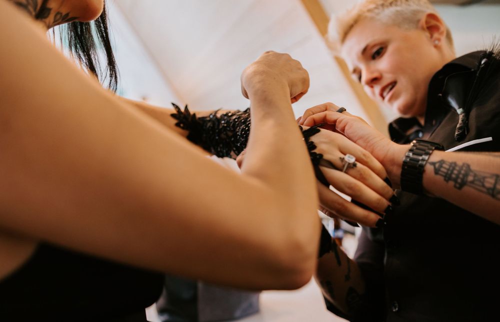 Two people exchanging rings during an intimate ceremony.