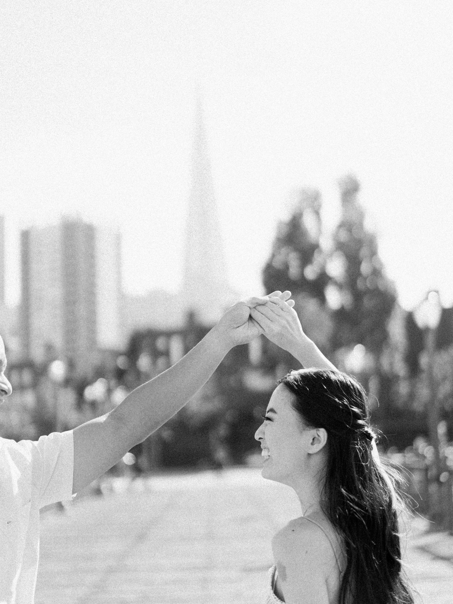 A romantic couple dancing on a pier with the San Francisco skyline and Transamerica Pyramid in the background.