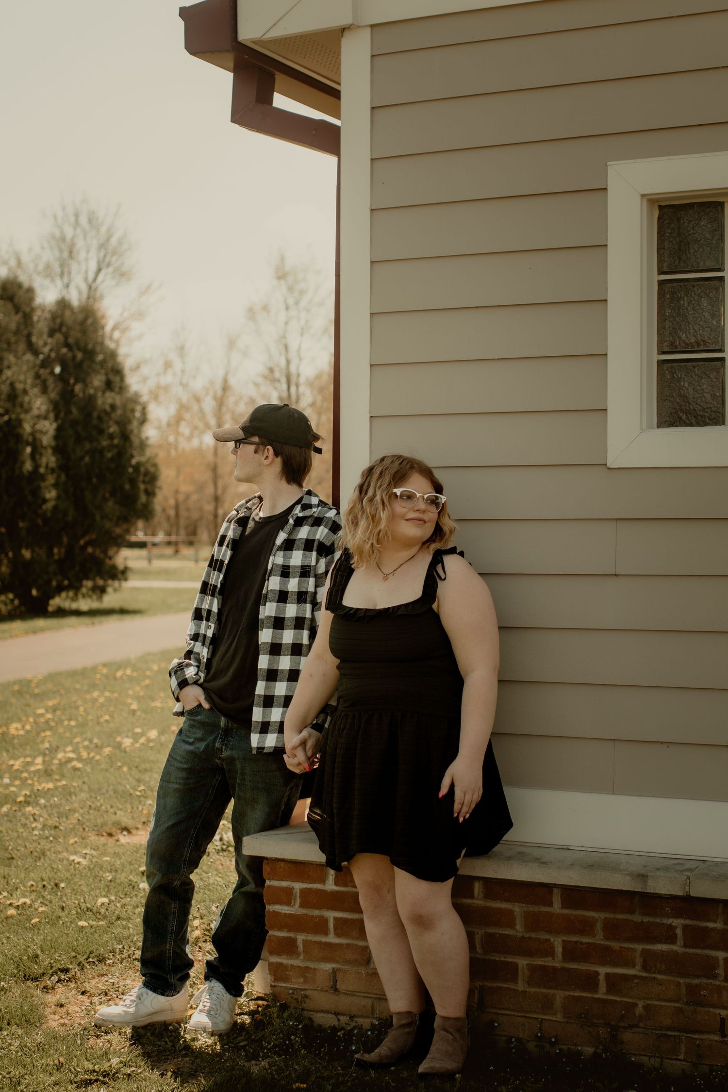 Earthy couple holding hands