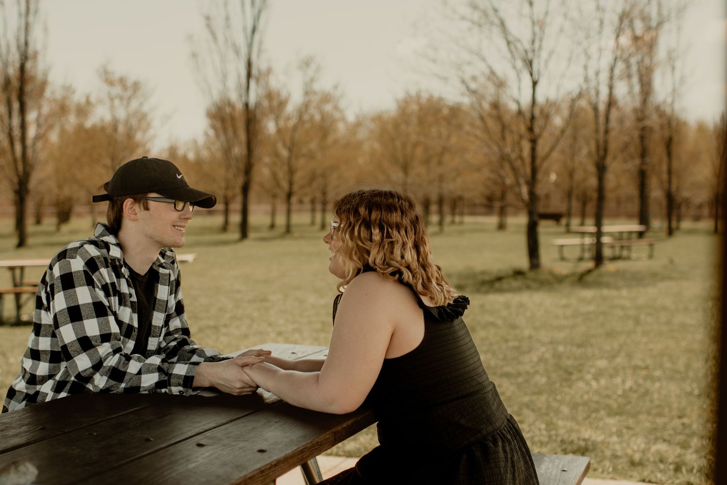 Couples holding hands in a park.