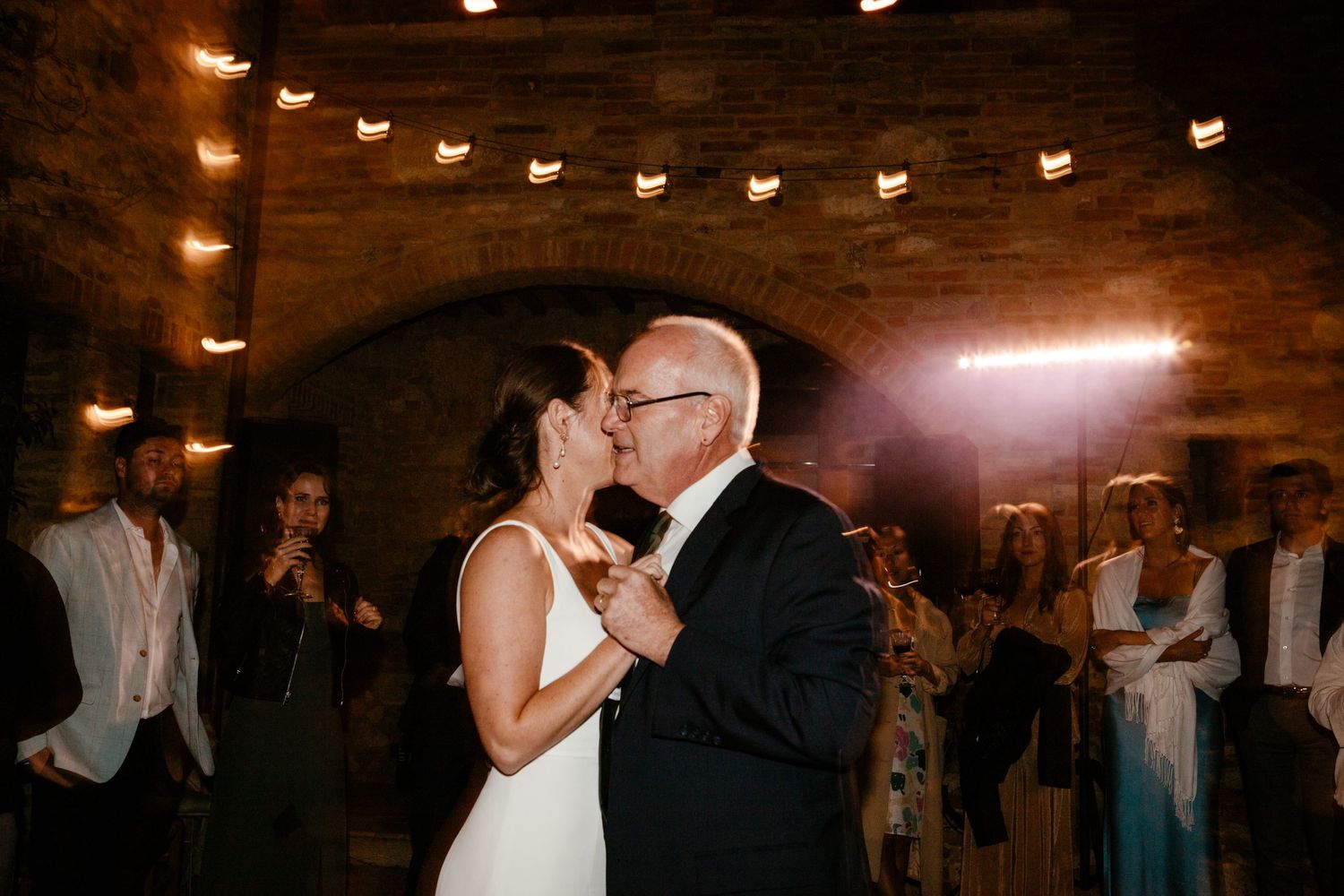 Father of the bride and daughter dance at a wedding in Tuscany.