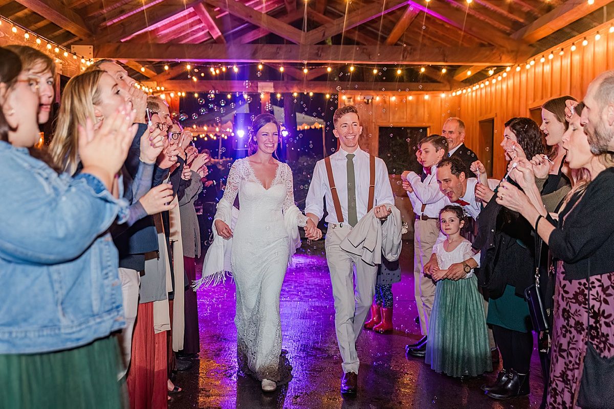 Bride and groom exit through bubbles at wedding reception by Indianapolis Indiana wedding photographer Jayme Riggleman