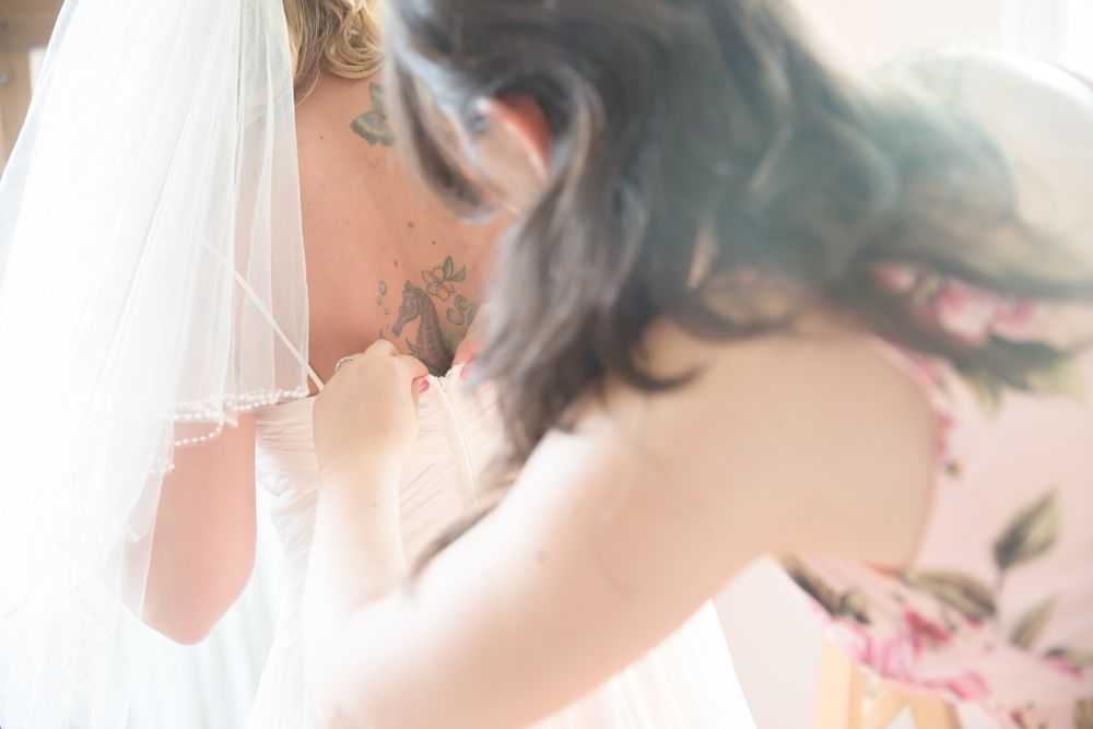Soft focus romantic moment captured through wedding veil with floral details.