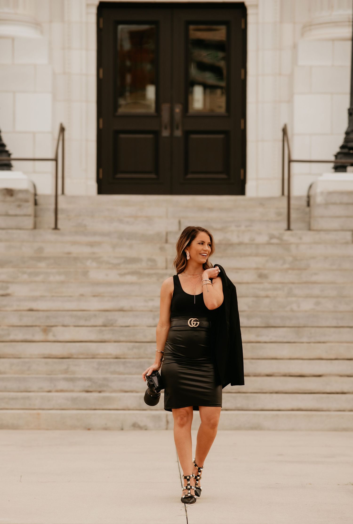 A beautiful woman, the photographer, showing her lens where she makes all her magic.