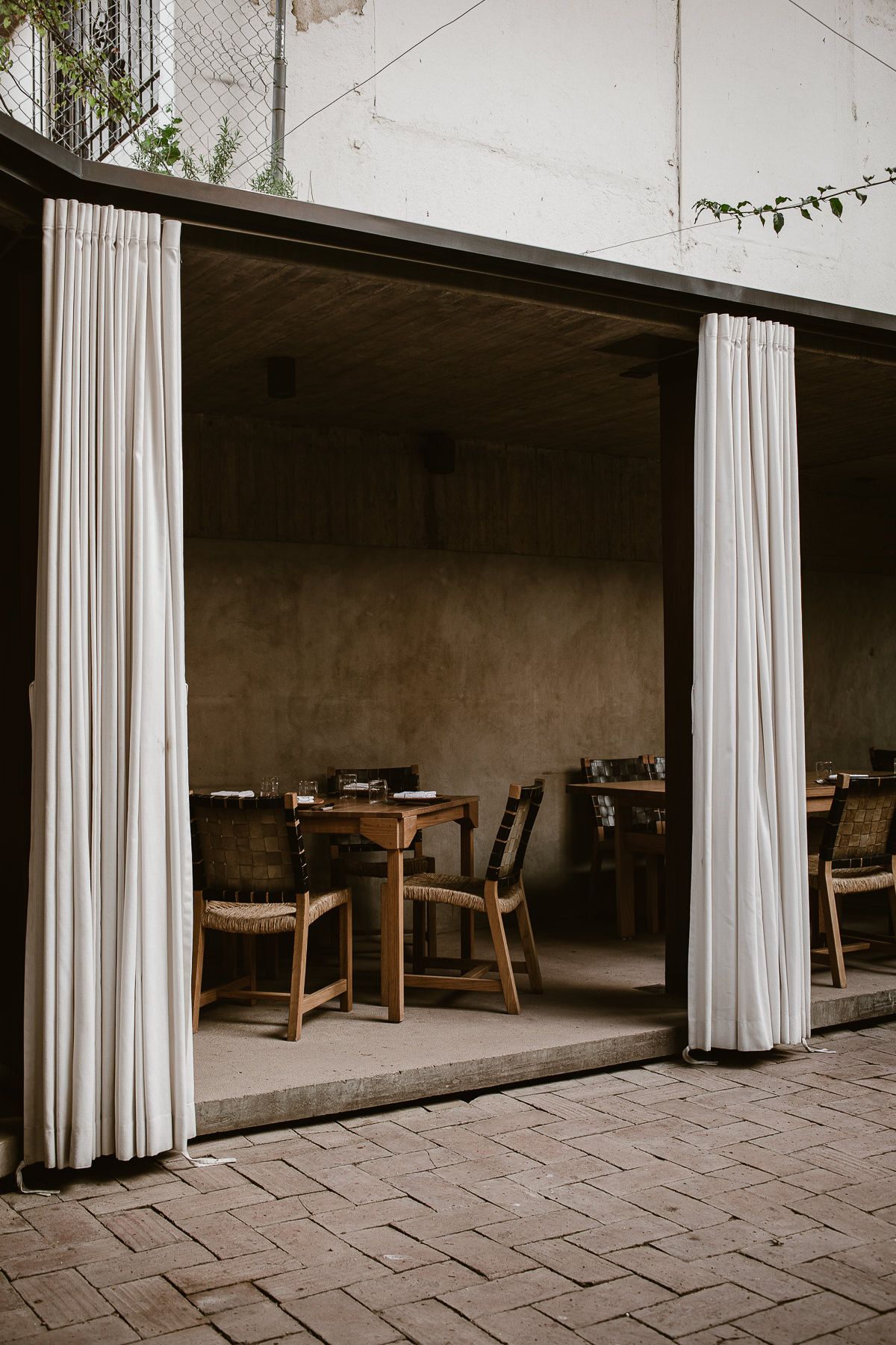 Set table with chairs and curtains in the restaurant Criollo in Oaxaca, Mexico