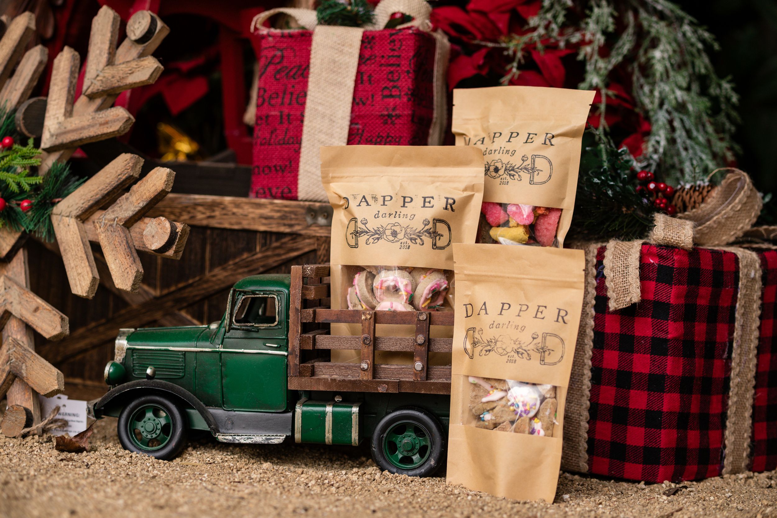 Dapper brand horse treat bags displayed with a green toy truck and Christmas gifts.