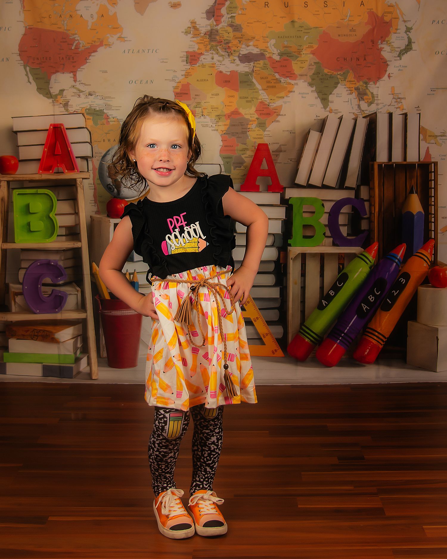 School themed portrait with colorful blocks and world map background in classroom setting.
