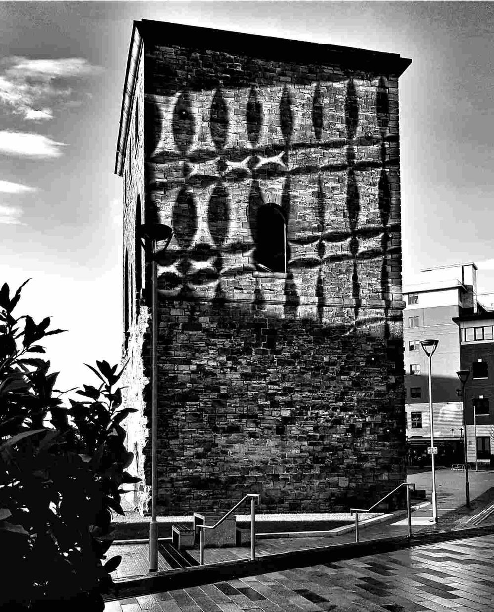 paul heaney photography railway engine lifting heritage building with sunlight reflections from adjacent office windows