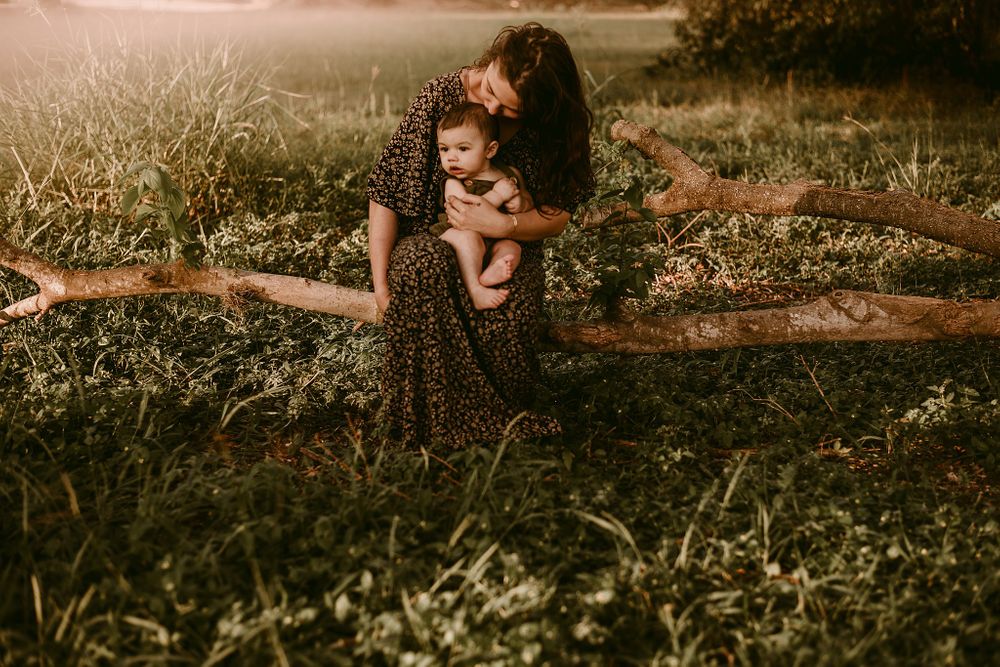 A tender outdoor moment photographed in warm evening light.