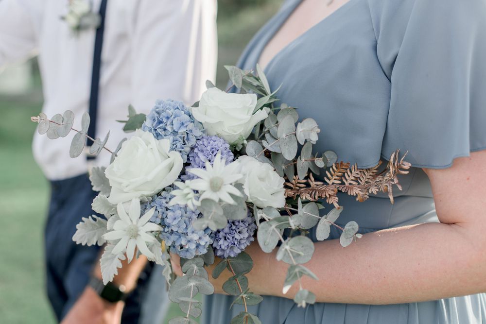 blue and white wedding bouquet with roses blue hydrangeas and native australian flannel flowers