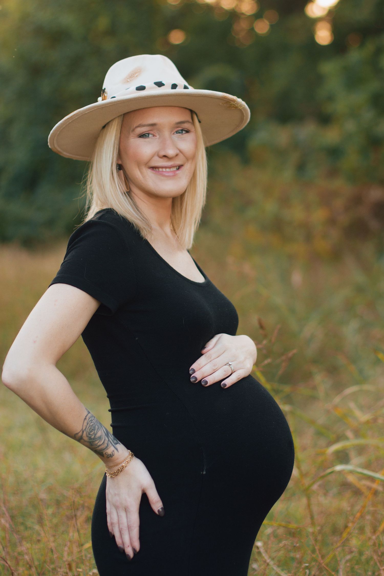 a pregnant mother in a field photographed by Delta Blossoms Photography in Manila, Arkansas
