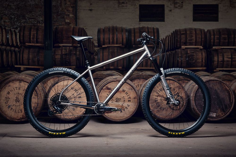 An On-One Vandal mountain bike photographed in the White Peak distillery (single malt whiskey barrels in background).