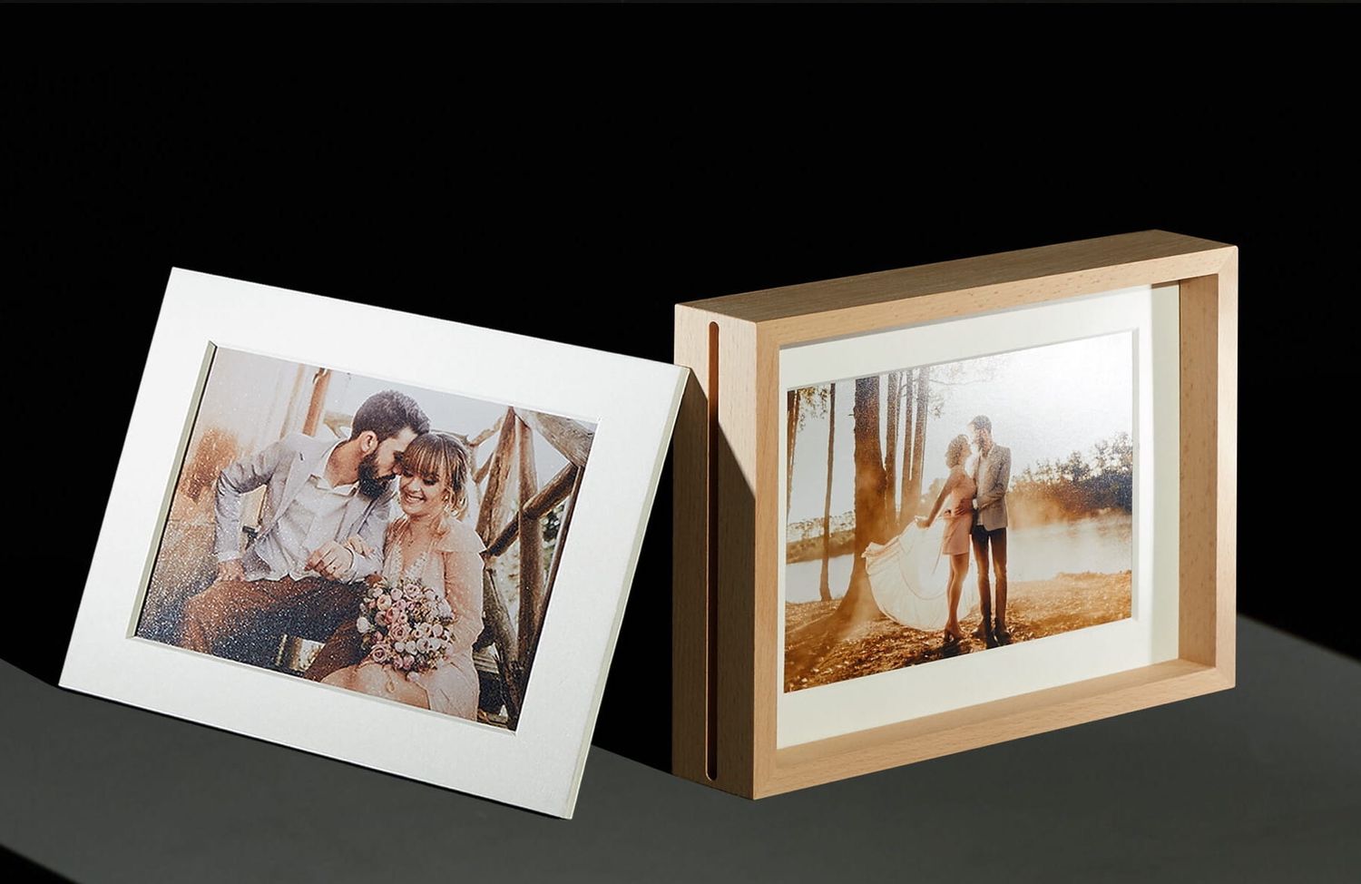 Two framed wedding photographs displayed against a dark background.