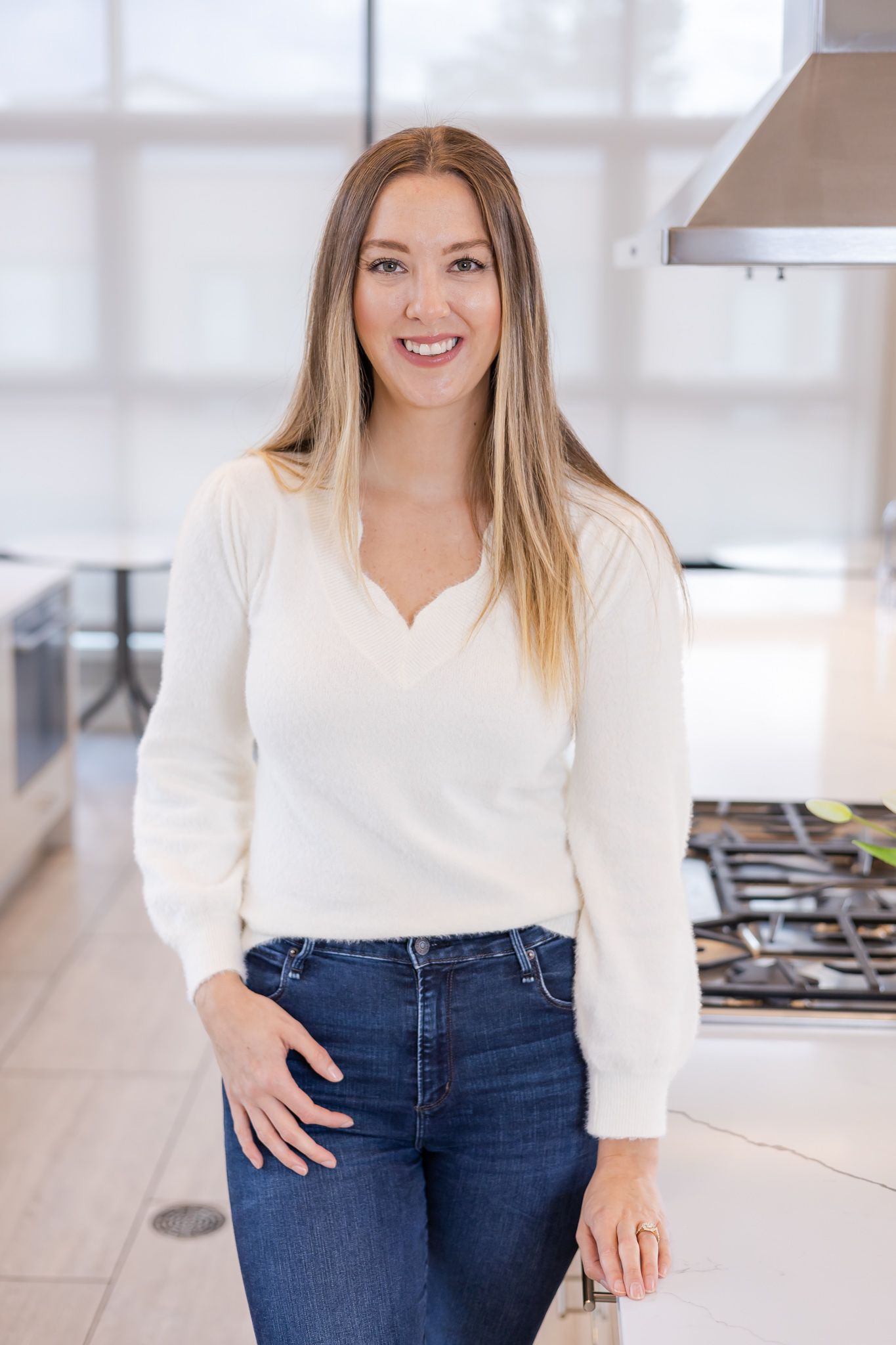 woman standing in kitchen with hand on counter for headshots in Woodinville, WA