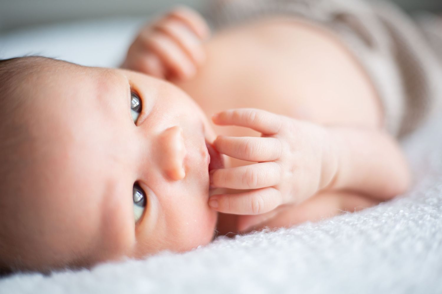 close up of newborn hands and face