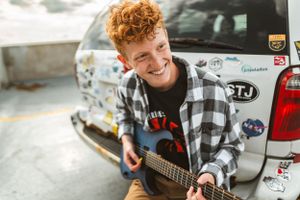 Boy senior photo session with his favorite guitar.