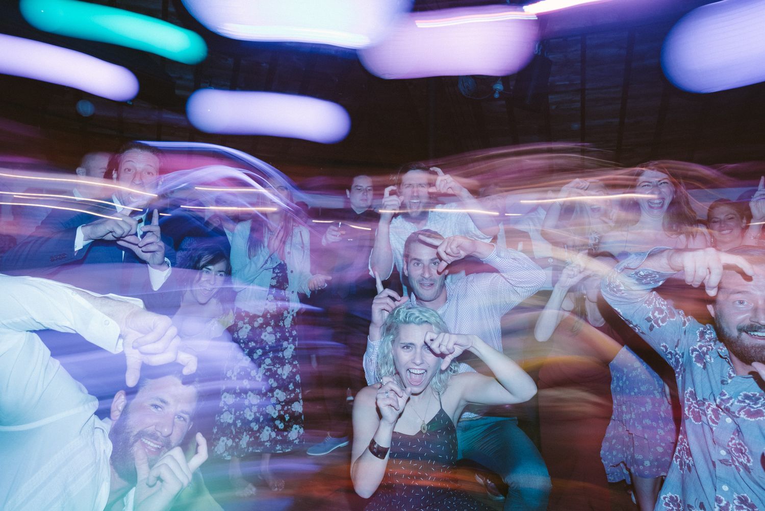 Abstract motion blur photograph of dancers performing with colorful lighting effects.