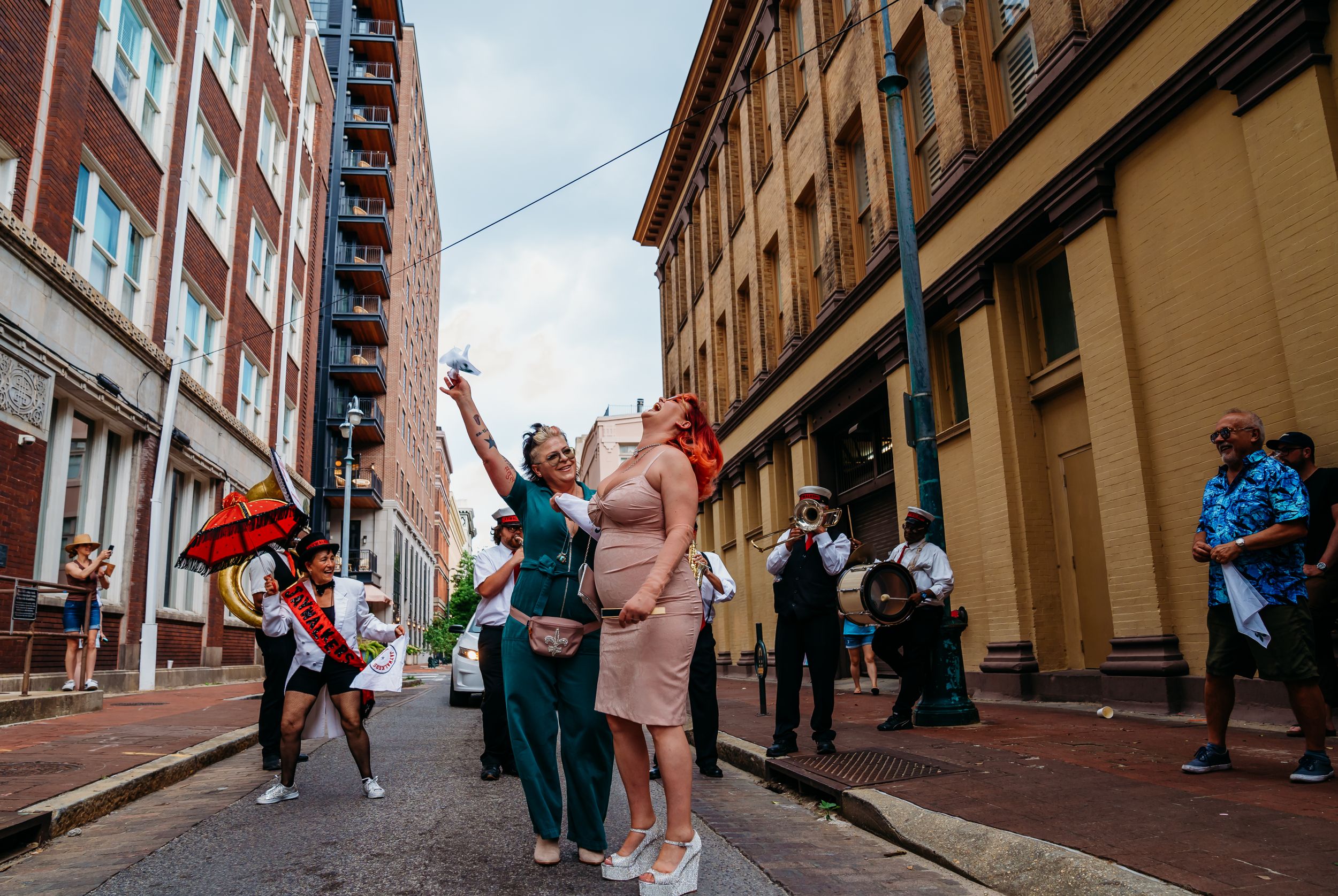 A couple happily shouts in front of their Second Line Band in the CBD on New Orleans.