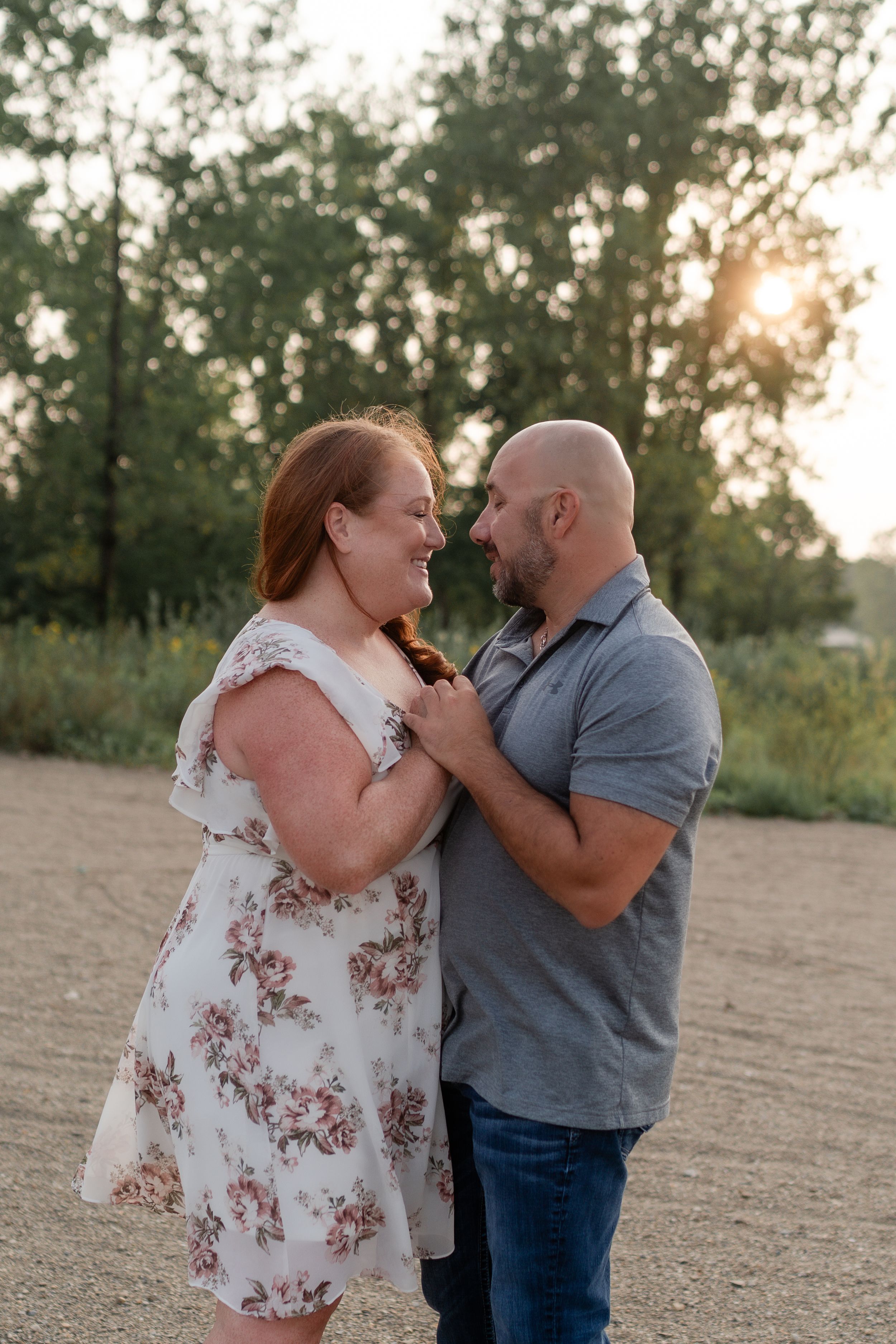 Couple sharing intimate moment on nature trail during golden hour.
