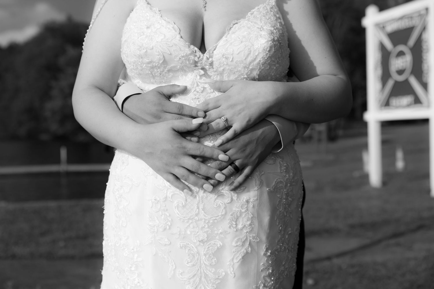 Close-up detail of intricate lace wedding dress bodice with sweetheart neckline.