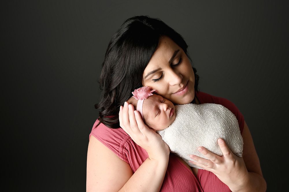 Portrait of mother with her new baby daughter