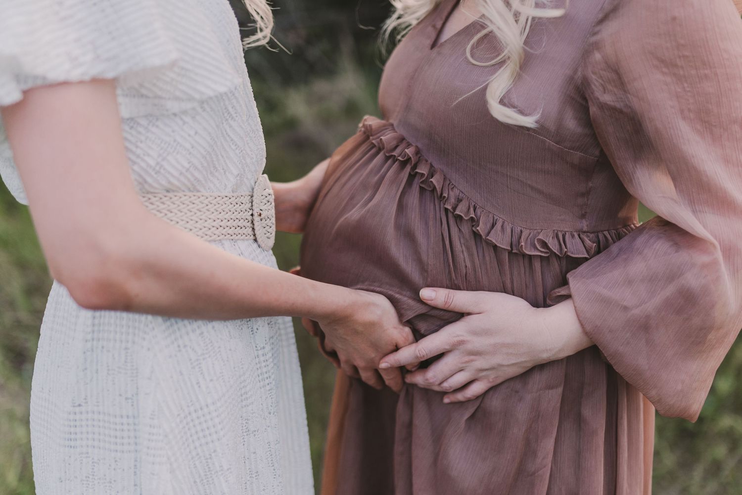 Close-up details of brown and white dresses in outdoor setting.