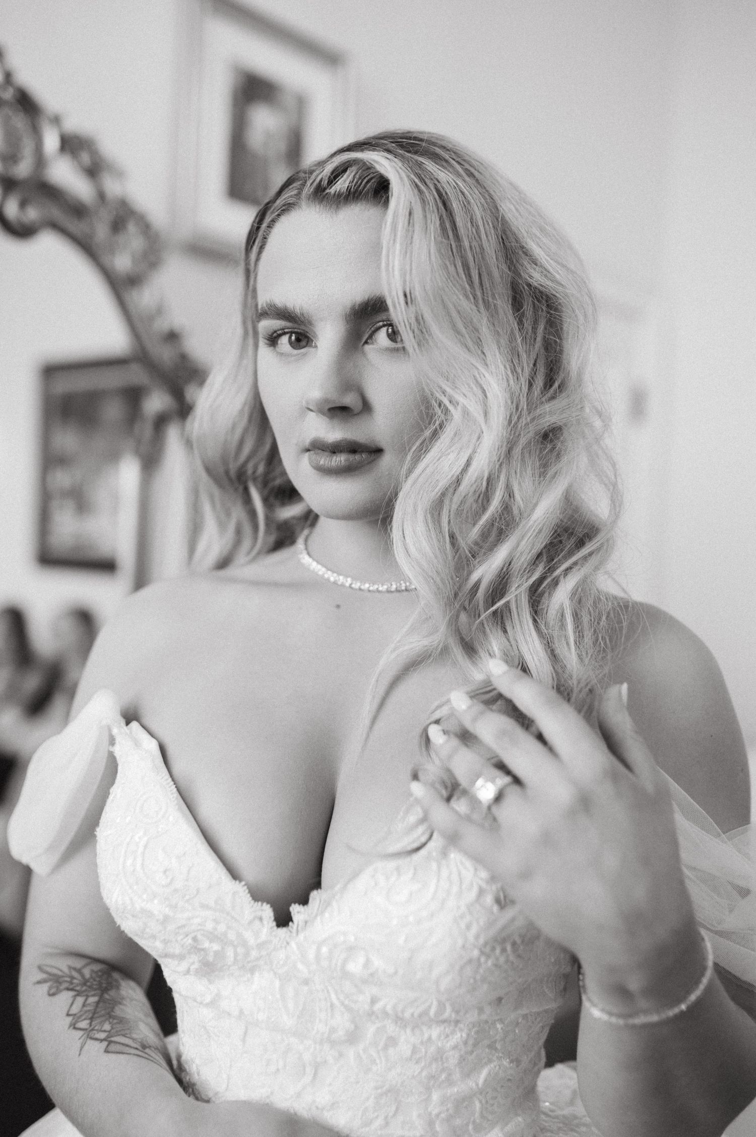Classic black and white bridal portrait showing elegant hair styling and pearl accessories.