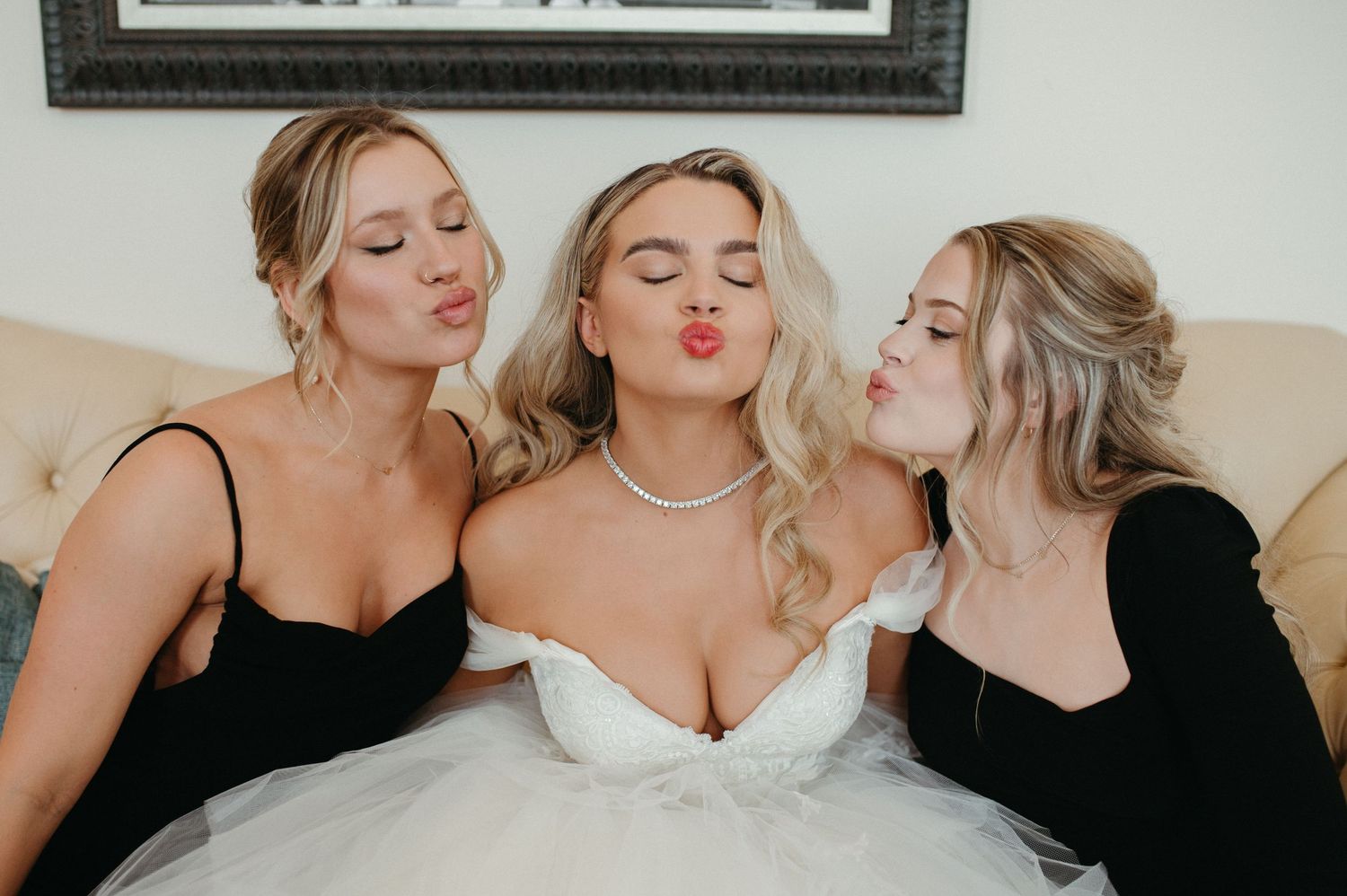 Fun candid portrait of bridesmaids in black dresses with the bride in traditional white.