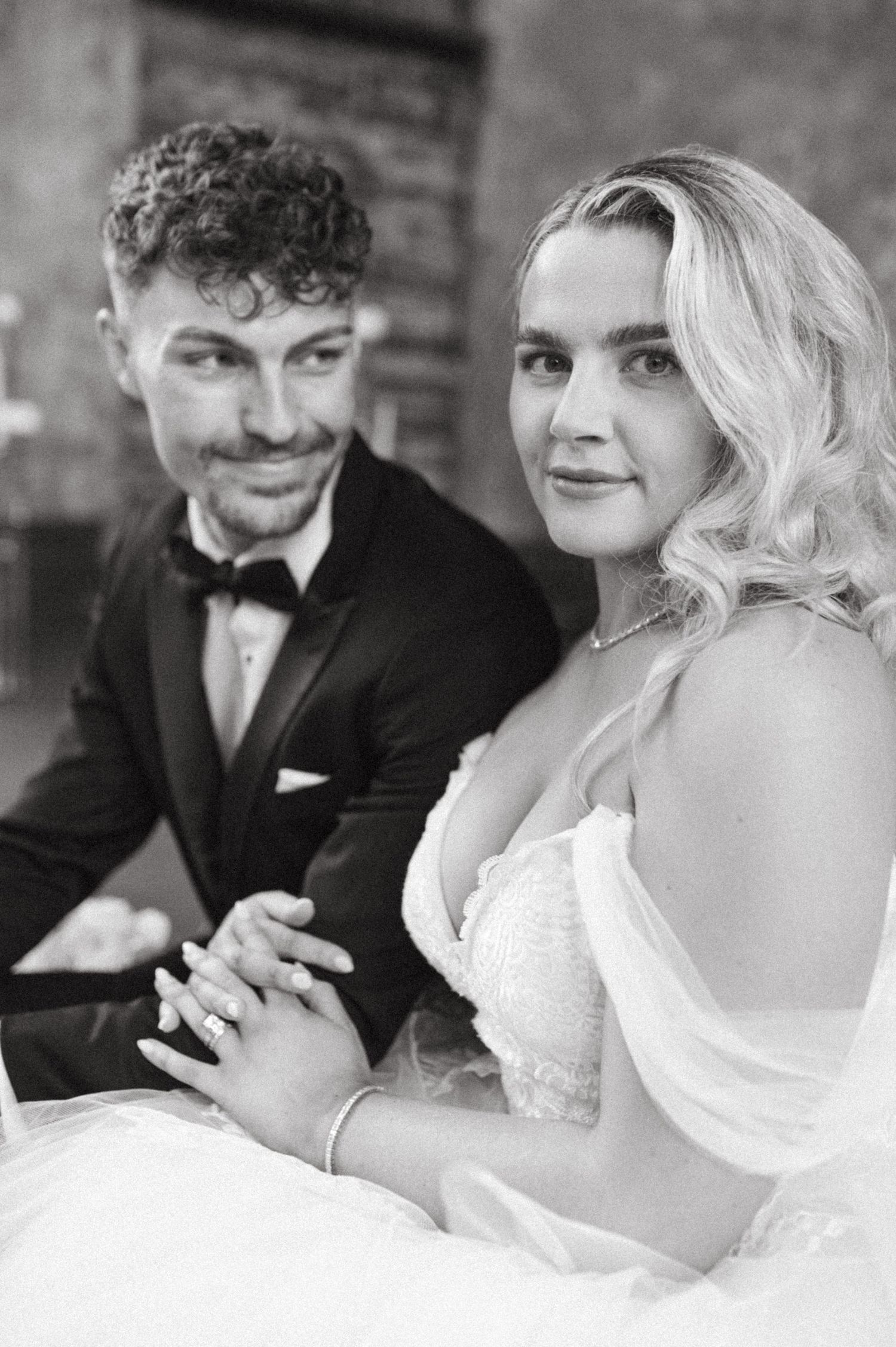 Black and white portrait of newlyweds showing vintage-inspired styling in historic setting.