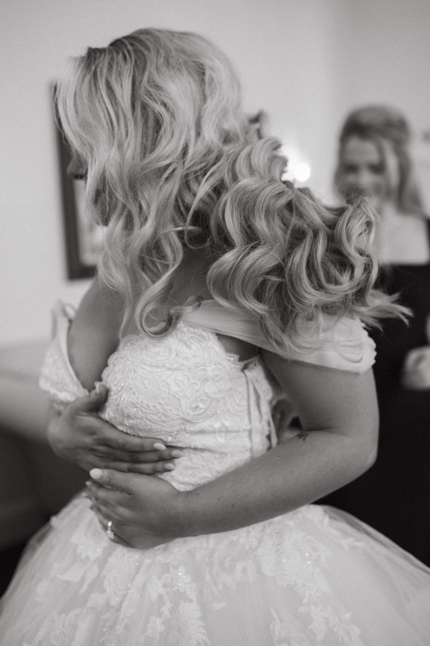 Black and white photo showing the detailed back of a lace wedding gown.