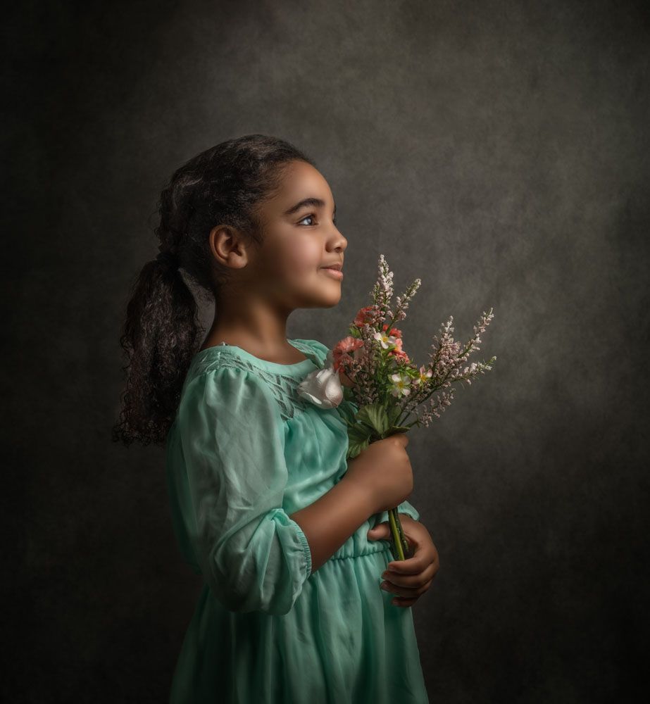 Fine Art Phtography of girl in green dress holding flowers