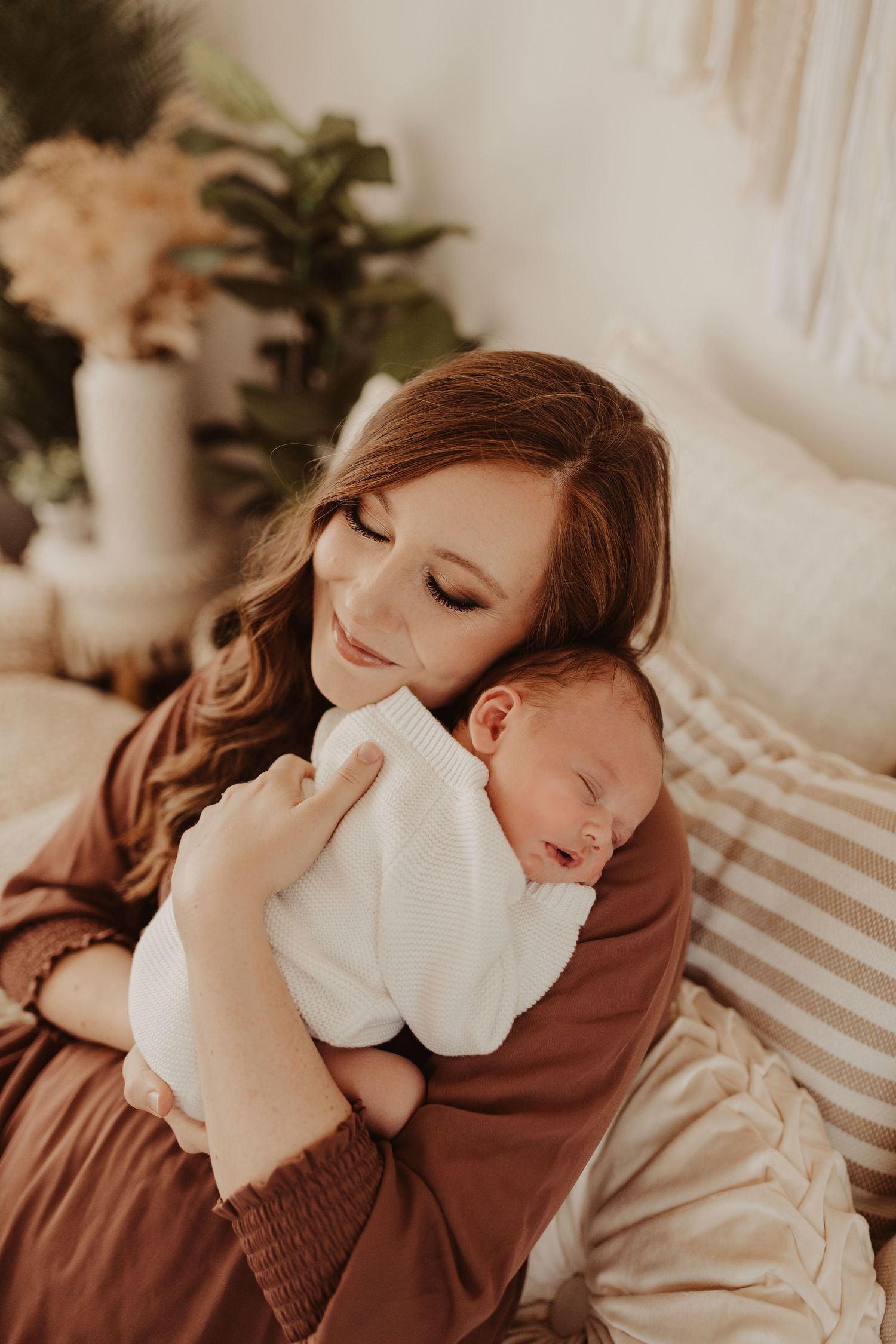 mom snuggles newborn photography session