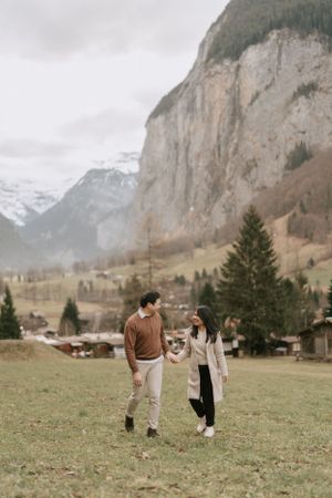 Scenic mountain engagement photos with dramatic cliffs and alpine meadows.