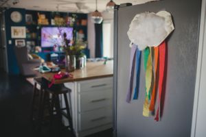 Colorful ribbons and decorations hang from the ceiling in a dimly lit room.