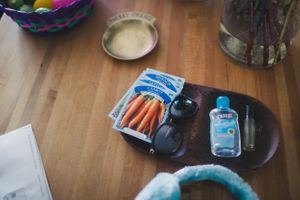 Various personal items and accessories scattered across a wooden floor.