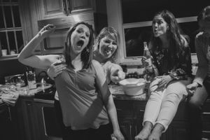 Black and white candid photos showing people laughing and having fun in a kitchen setting.