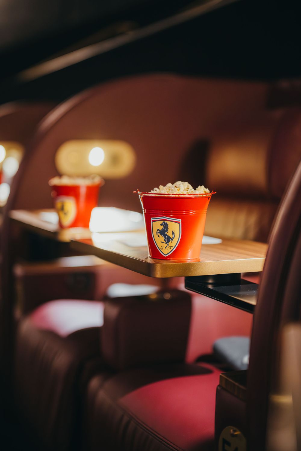 Ferrari branded cups and snacks displayed on restaurant table.