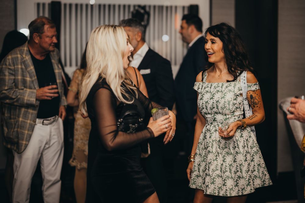 Guests mingling at an elegant evening social event.