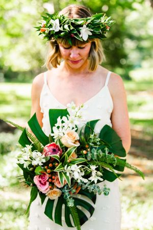 Oahu Hawaii elopement photographer capturing romantic garden portraits of bride with wedding bouquet.