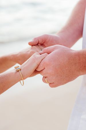 Oahu Hawaii elopement photographer capturing romantic sunrise portraits of couple holding hands.