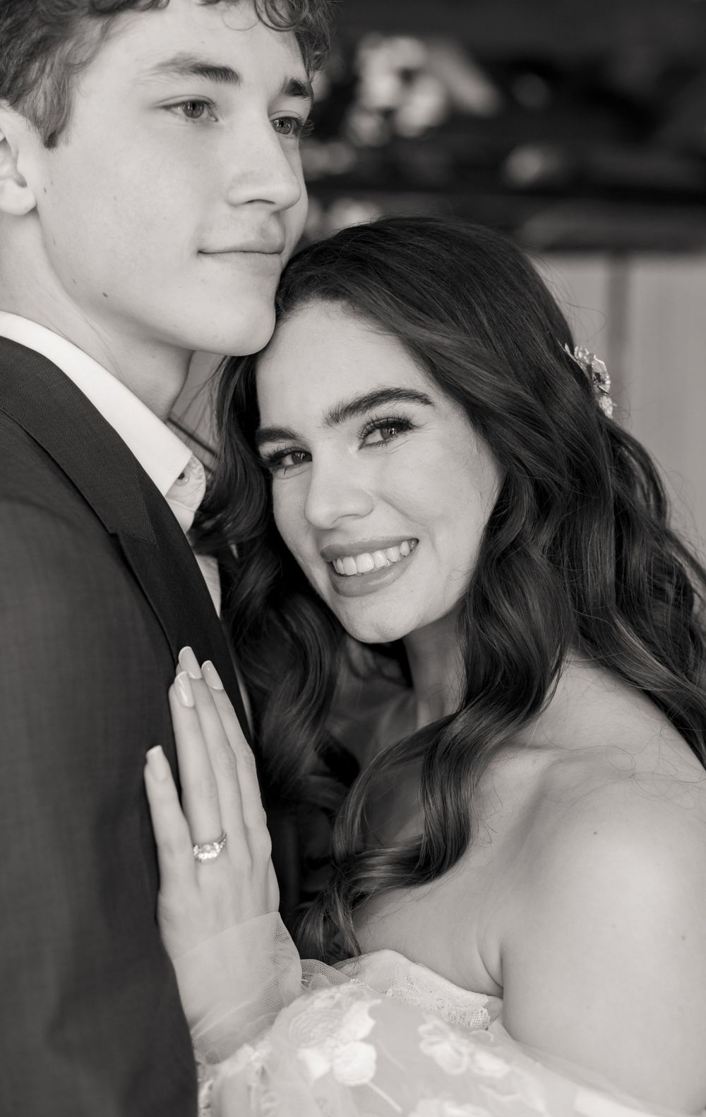 Black and white close-up portrait of newlyweds sharing an intimate moment.