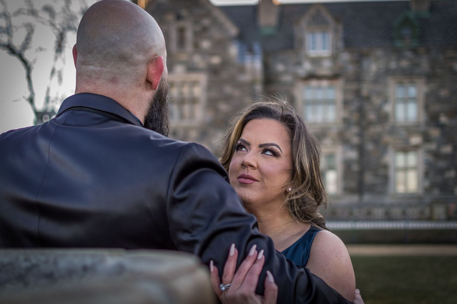 Romantic outdoor portrait session with historic building in background.