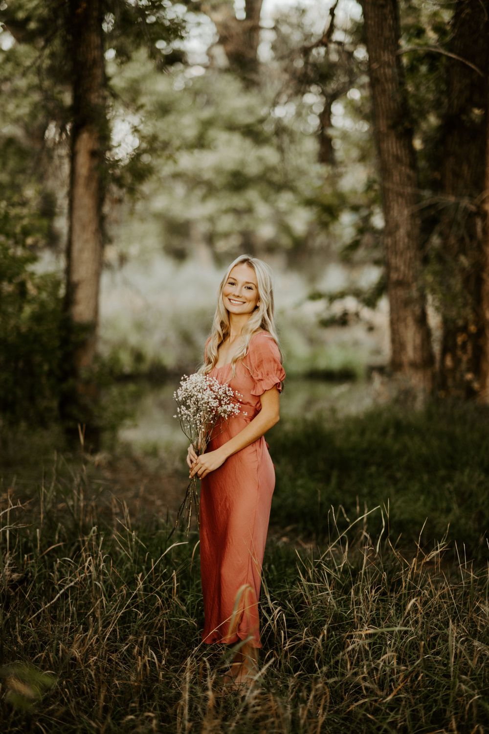 high school senior surrounded my trees