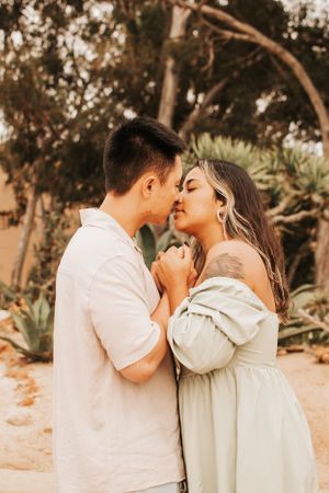 Romantic couple sharing an intimate moment in warm sunset lighting.