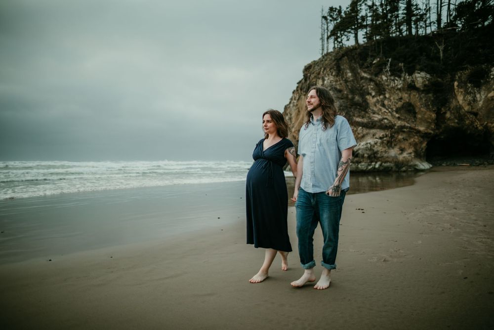 couple walking down coast line maternity photographer portland oregon